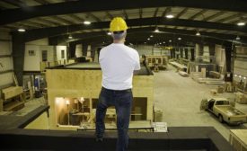 man in a hardhat standing in a warehouse